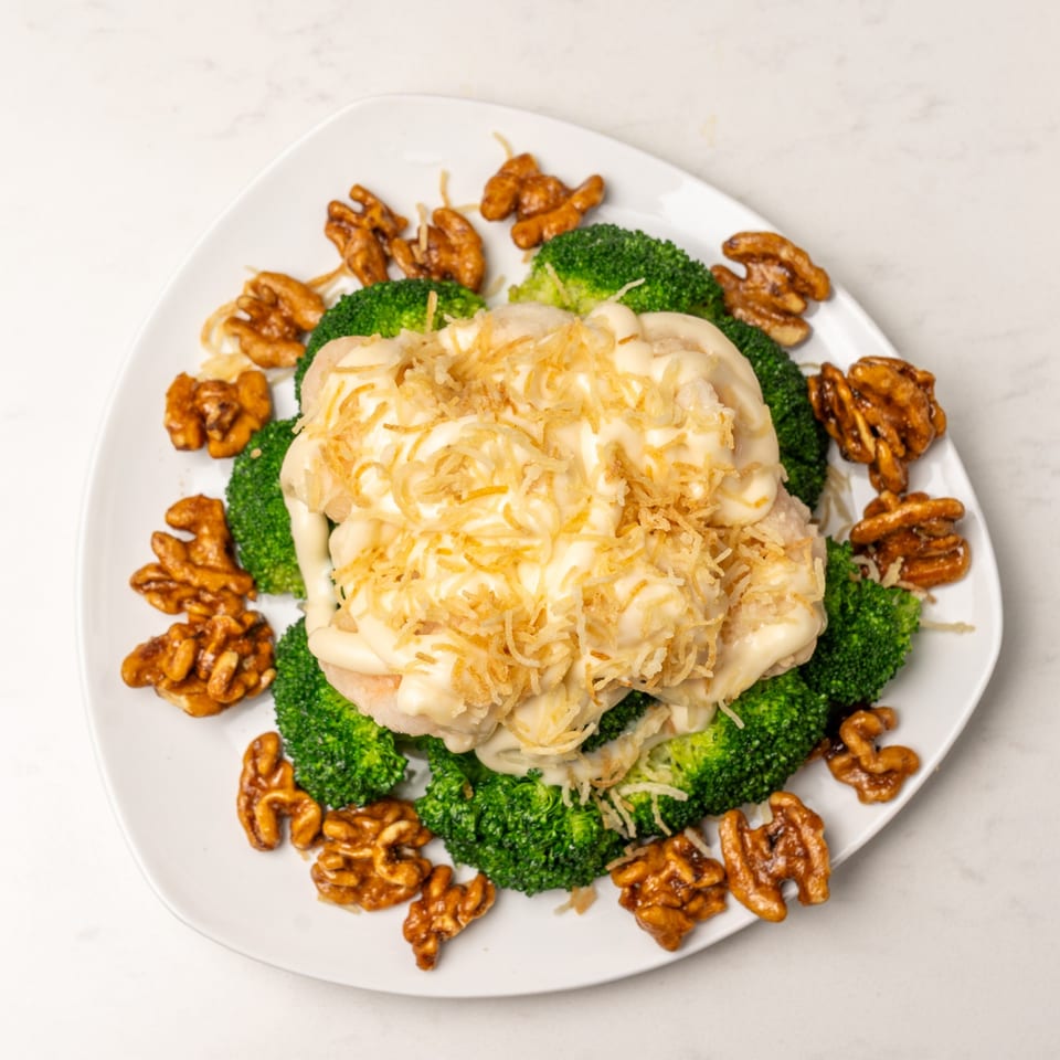Mei Lai Xuan's honey walnut shrimp with broccoli and crispy noodles on a white plate.