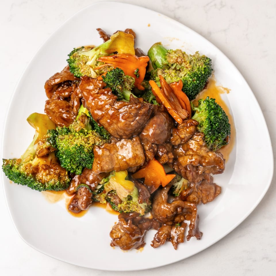 Mei Lai Xuan's beef and broccoli stir-fry with carrots and a rich brown sauce on a white plate.